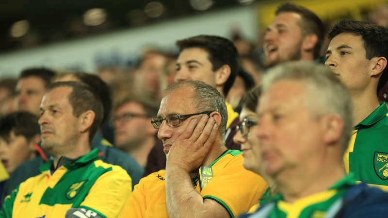 Norwich fans react to their team's relegation from the Premier League