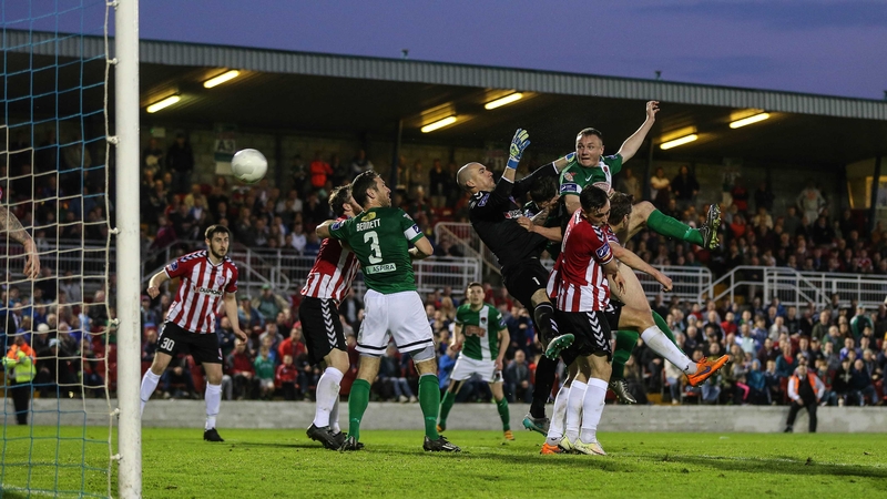 Kenny Browne beats Gerard Doherty to the ball to head Cork to victory
