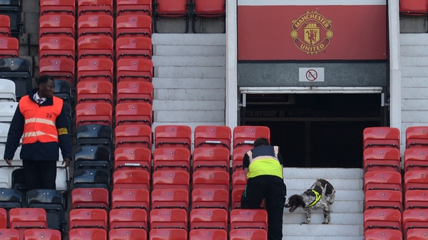 A sniffer dog searches the stands at Old Trafford in Manchester