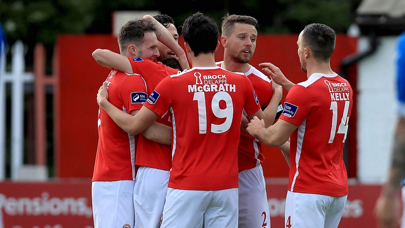 Mark Timlin is mobbed by his team-mates after scoring his first goal of the night at Richmond Park
