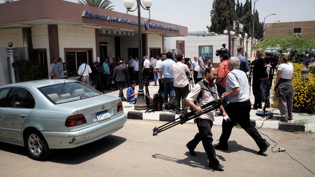 Journalists gather in front of the EgyptAir in-flight services building