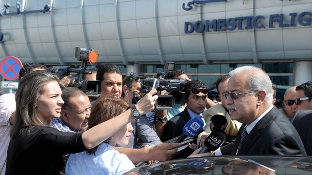 Egyptian Prime Minister Sherif Ismail talks to reporters