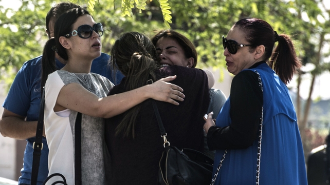 Relatives of passengers wait outside a services hall at Cairo airport