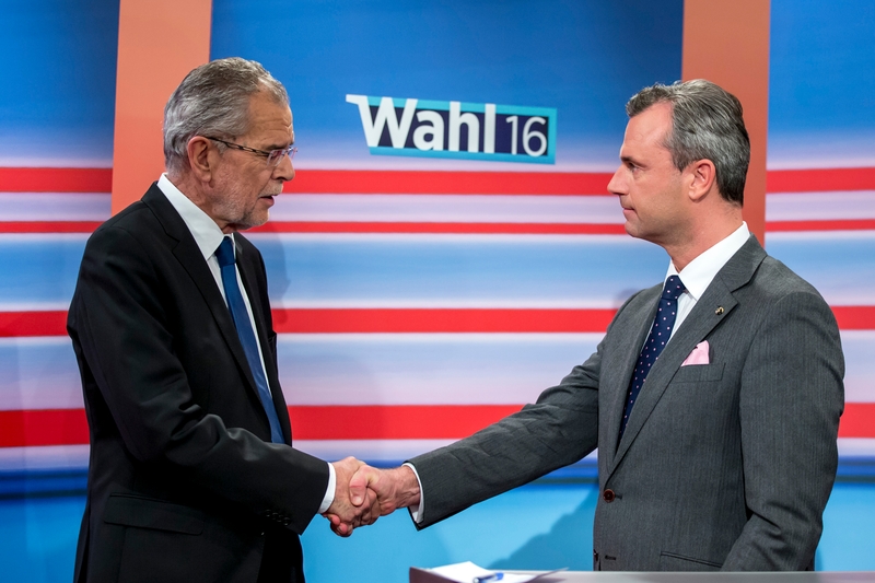 Candidates Alexander van der Bellen (L) and Norbert Hofer (R) shake hands at the state broadcaster in Austria