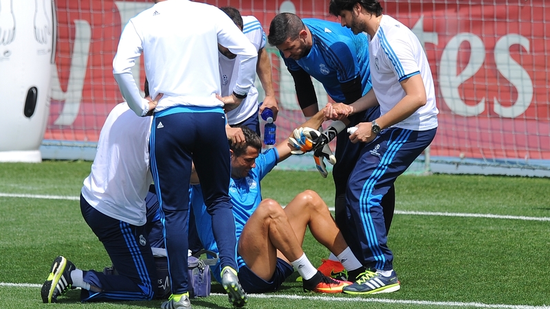 Trainers attend to Ronaldo after he suffered a thigh problem at Real Madrid training