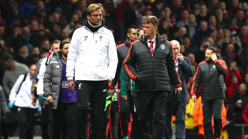 Managers Louis van Gaal and Jurgen Klopp walk the touchline prior to the Europa League match at Old Trafford