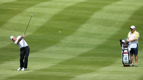 Graeme McDowell plays his second shot on the fourth hole today