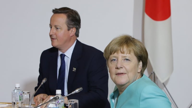 British Prime Minister David Cameron and German Chancellor Angela Merkel meet at the G7 summit in Tokyo