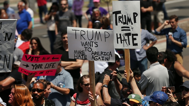 Outside the convention centre in San Diego demonstrators carried signs criticising Donald Trump's rhetoric against illegal immigration