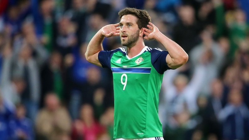 Will Grigg celebrates scoring his side's third goal against Belarus