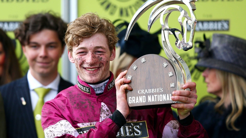 David Mullins poses with the winner's trophy after riding Rule The World to victory at Aintree