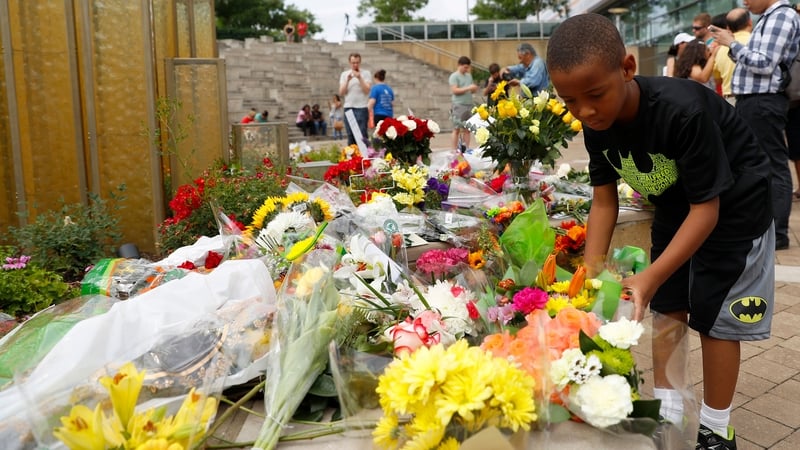 Mourners leave flowers at a memorial following the death of boxing legend Muhammad Ali outside the Muhammad Ali Center