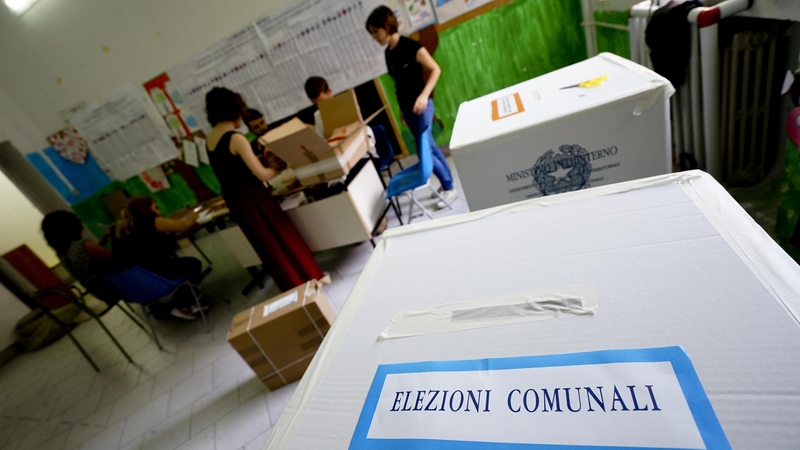 Clerks at a polling station in Naples earlier today