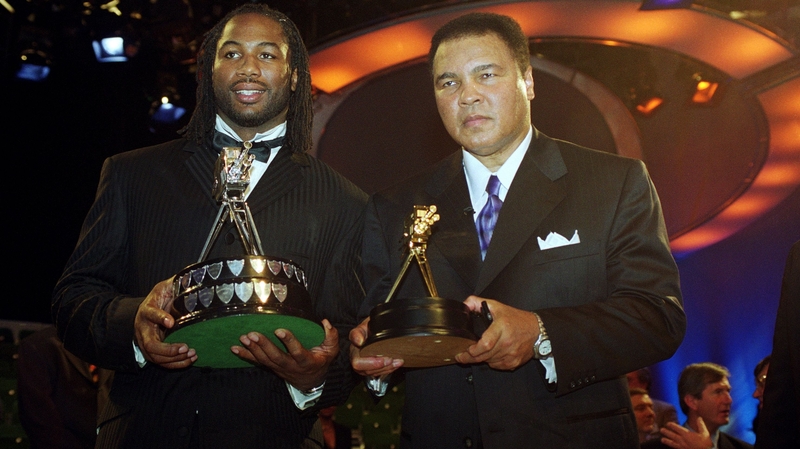 Lennox Lewis (L) and Muhammad Ali pose for the cameras at the BBC Sports Personality of the Year Awards ceremony in 1999