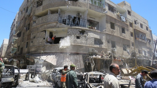 At least 20 people were killed and scores wounded in twin suicide and car bomb blasts in a Damascus suburb yesterday