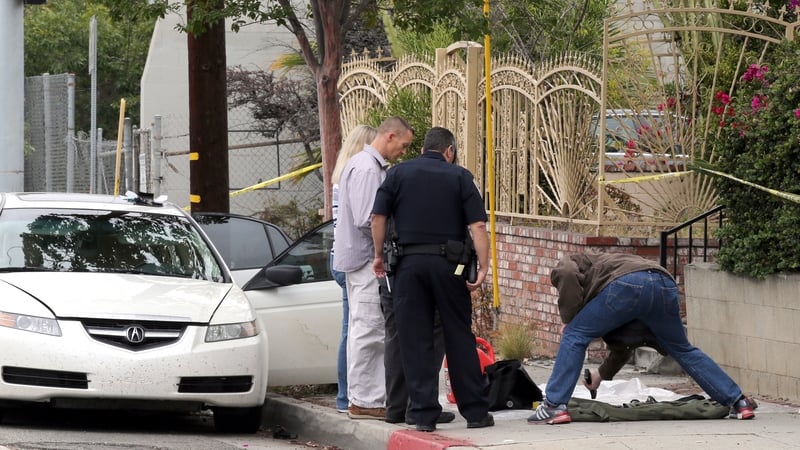 Police officers examine evidence taken from the car