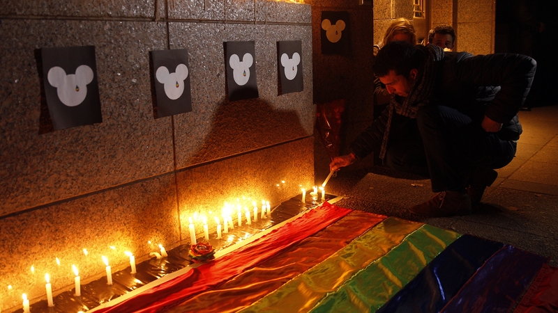 A member of an LGBT group lights candels during a vigil in honor to the victims of a mass shooting in Santiago de Chile, Chile