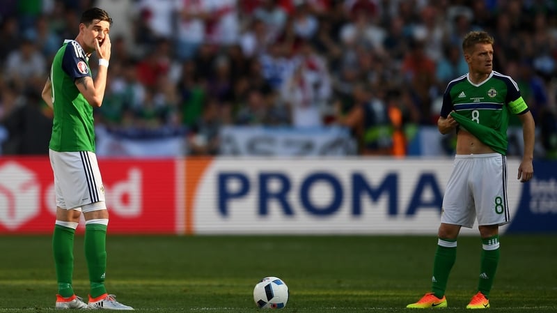 Kyle Lafferty (L) and Steven Davis look dejected during Northern Ireland's loss to Poland