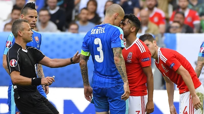 Wales' defender Neil Taylor squares up to Slovakia captain Martin Skrtel during the sides' recent game