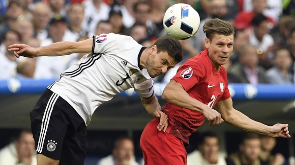 Jonas Hector vies for the header with Polish defender Lukasz Piszczek