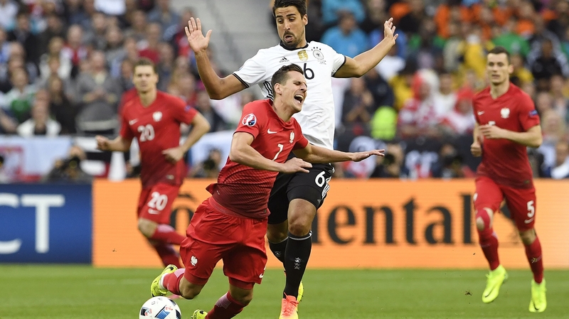 Sami Khedira fouls Poland's forward Arkadiusz Mili