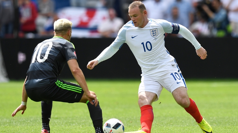 Wayne Rooney takes on Wales' Aaron Ramsey in Lens