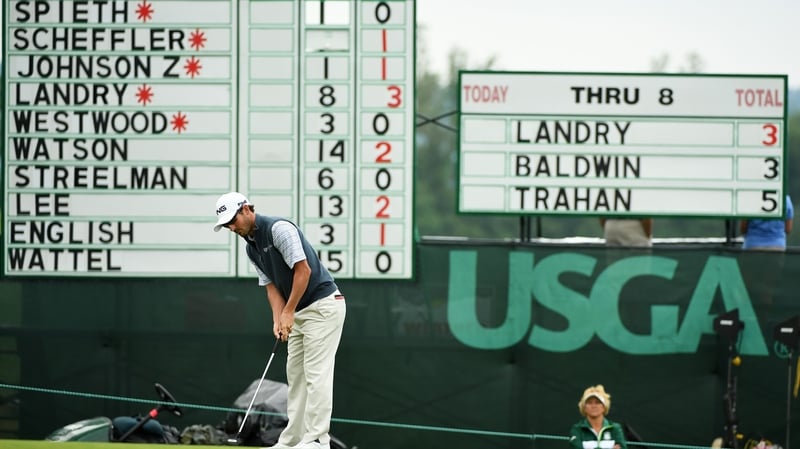 Landry sinks his history making putt in front of the leaderboard on the ninth green at Oakmont