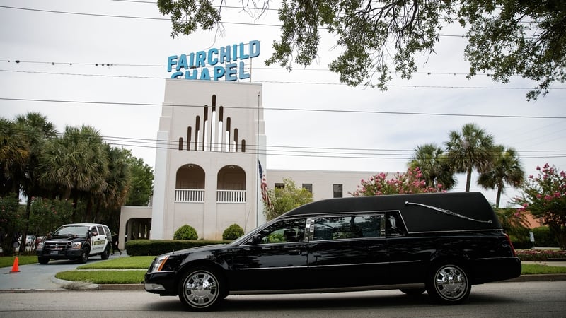 A hearse drives past Baldwin-Fairchild Funeral Home in Orlando where a wake for Christopher 'Dru' Leinonen took place today