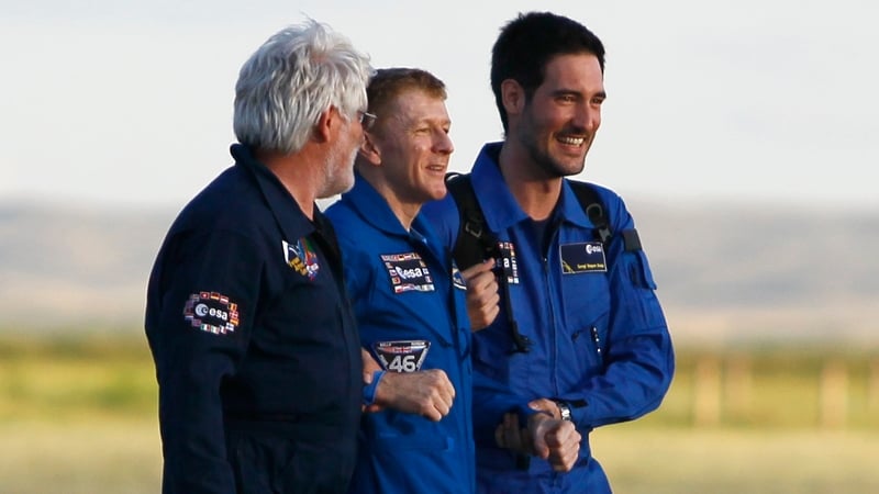 Tim Peake (C) is helped by colleagues upon his arrival at the airport of Karaganda, Kazakhstan