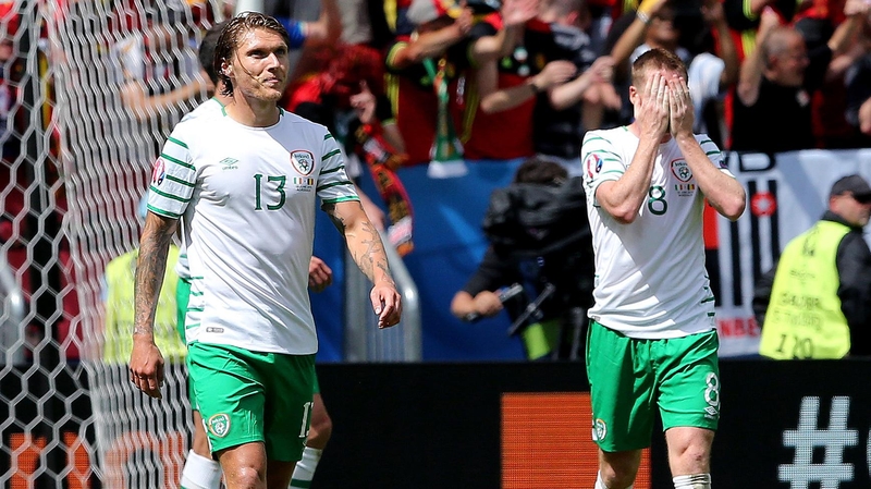 James McCarthy (R) holds his head in his hands after Axel Witsel's goal