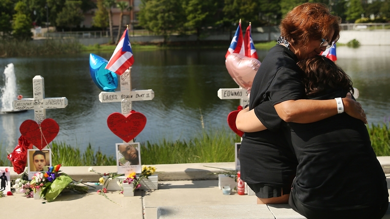 Two women embrace beside a memorial near the Pulse nightclub in Orlando, Florida