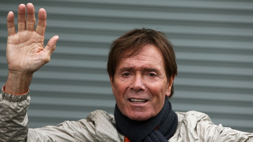 Cliff Richard waves to members of the press and fans last June