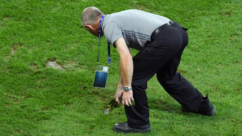 Ground staffs tend the pitch at the half time during the clash between Switzerland and France at Stade Pierre-Mauroy