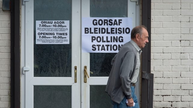 A voter leaves the Martyrs Club polling station in Merthyr, Wales