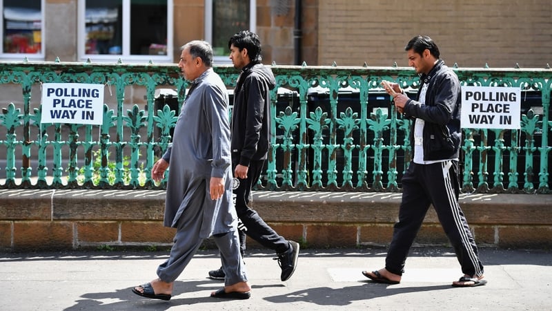 Men walking into a primary school polling station in Glasgow