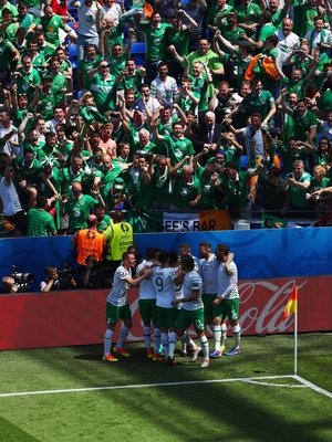 The Irish players celebrate in front of their supporters
