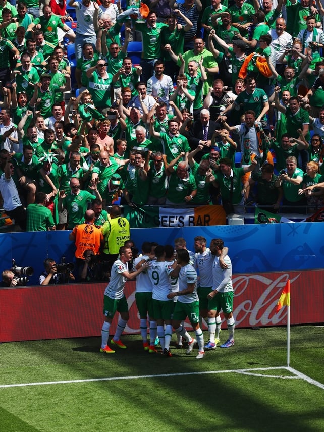 The Irish players celebrate in front of their supporters