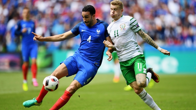 France's Adil Rami and James McClean fight for the ball