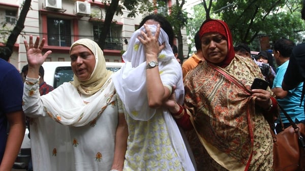 Relatives of victims are seen in a state of shock as they go to identify bodies from the siege in Dhaka, Bangladesh