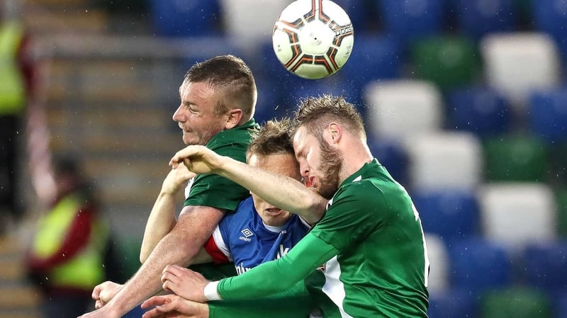 Linfield's Aaron Burns with Cork's Kenny Browne and Kevin O’Connor