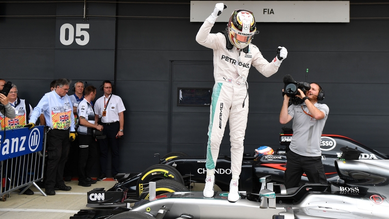 Lewis Hamilton celebrates after securing pole position