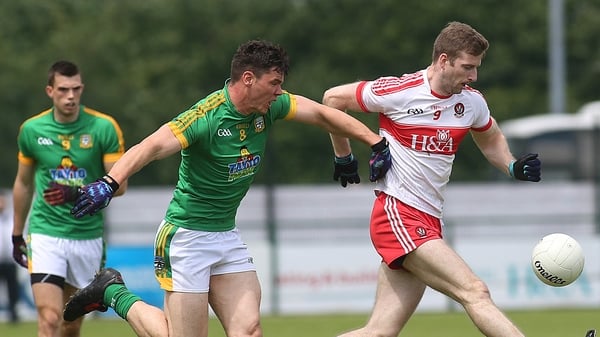 Derry's Brian Holly and Meath's Harry Rooney