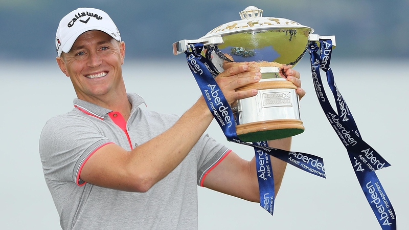 Alex Noren poses with the trophy
