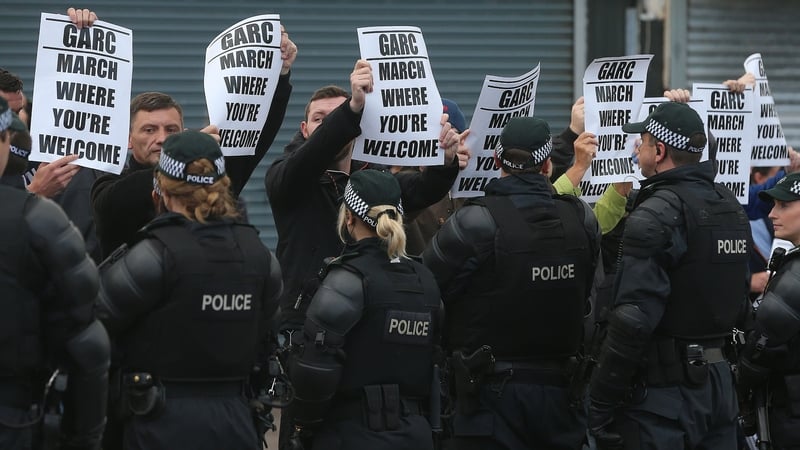 Protesters from the nationalist Ardoyne neighbourhood watch as members of the Orange Order pass