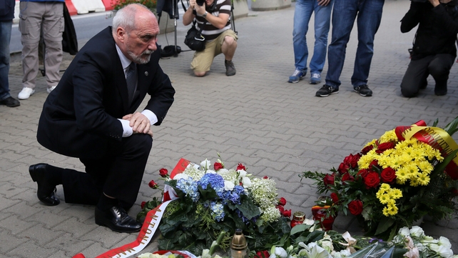 Polish Defence Minister Antoni Macierewicz lays flowers in front of the French Embassy in Warsaw, Poland