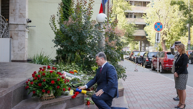 Ukrainian President Petro Poroshenko lays flowers at the French embassy in Kiev