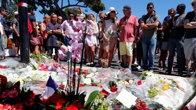 People gather near the scene of the attack in Nice