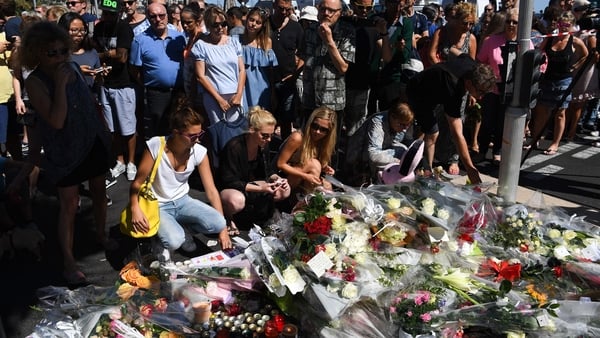 People lay flowers for the victims of the attack on the Promenade des Anglais