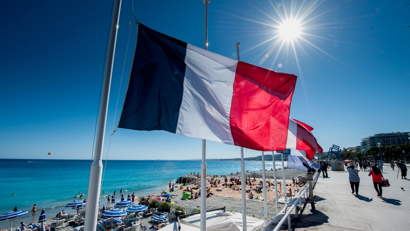 A flag is seen flying at half-mast along the 'Promenade des Anglais' where the truck crashed into the crowds on Thursday