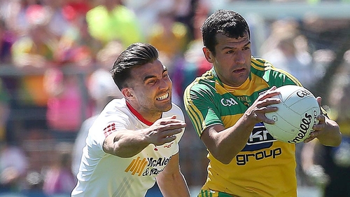 Tyrone's Tiernan McCann tackles Frank McGlynn